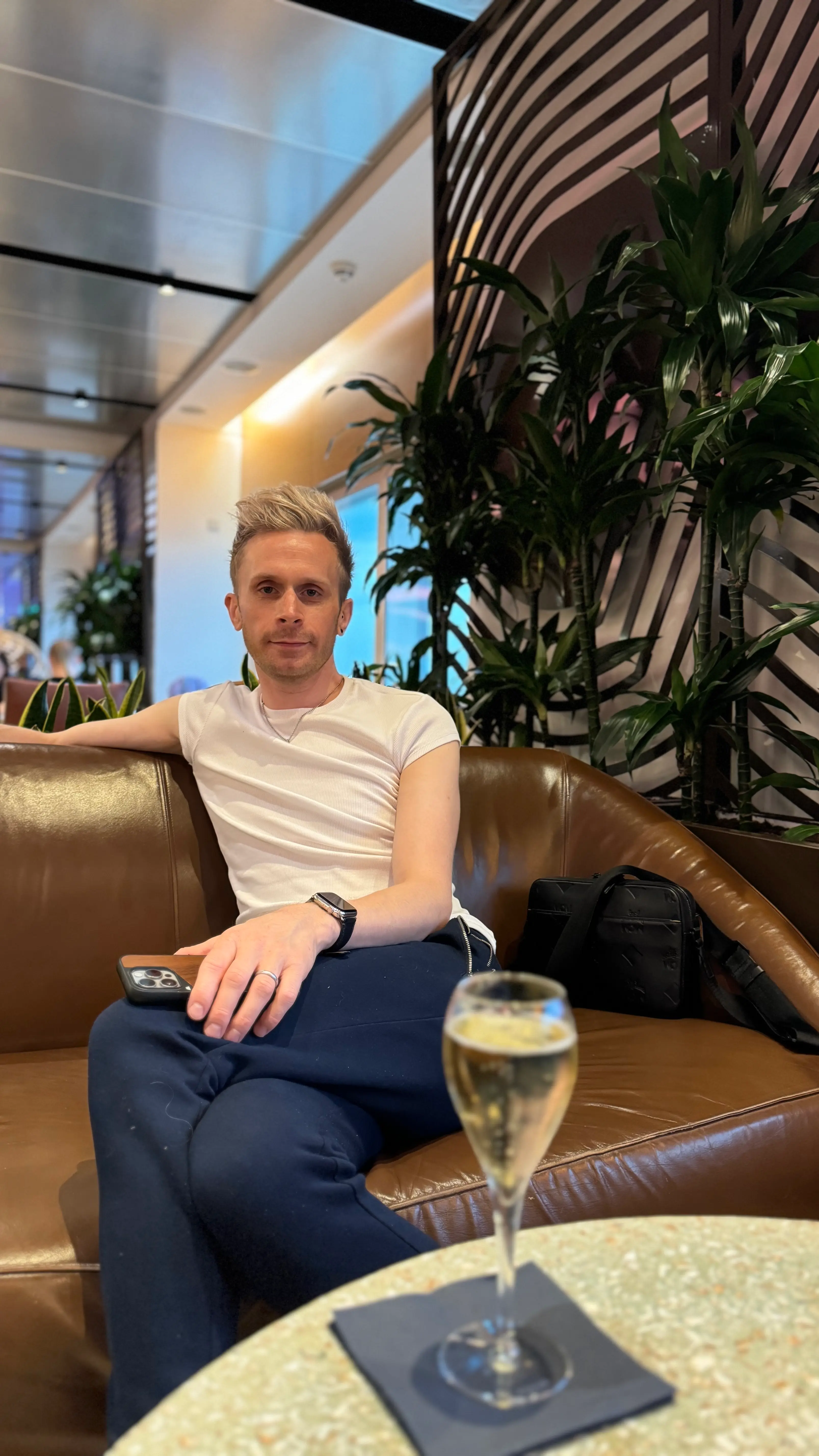 Joe drinking champagne in the Virgin Atlantic Upper Class Lounge at Heathrow