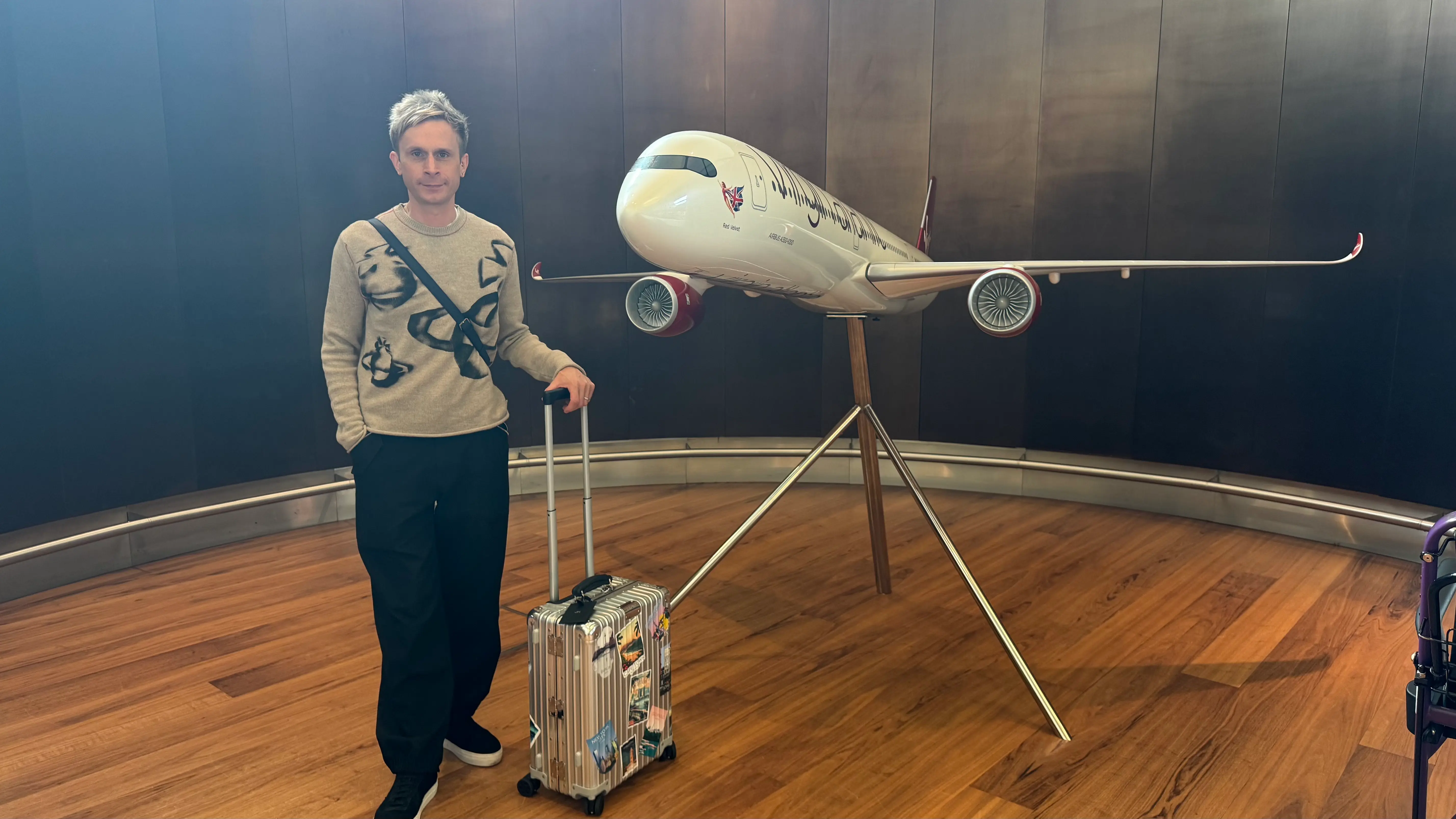 Joe in front of the Virgin Atlantic A350 Upper Class wing display at Heathrow Clubhouse