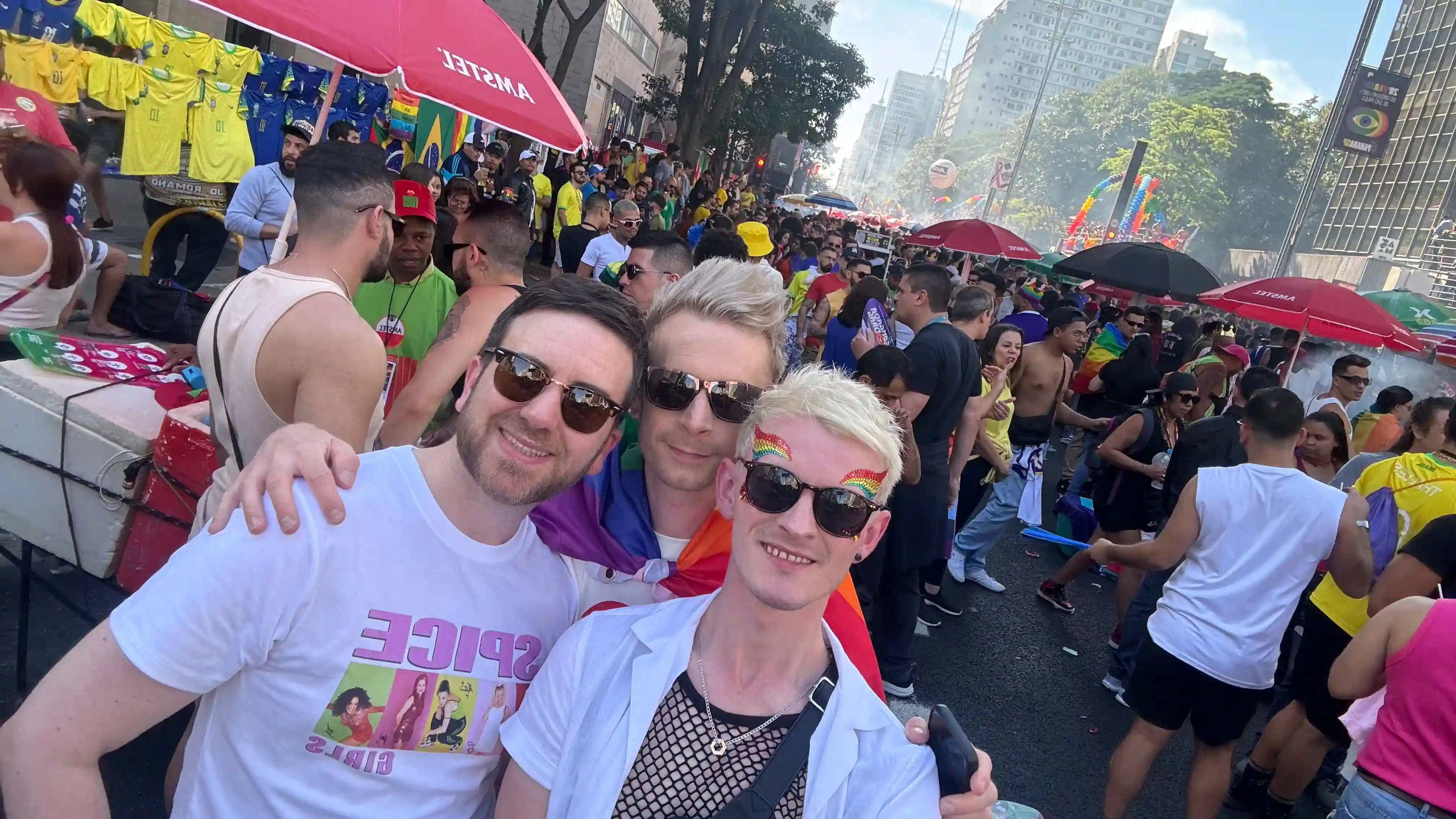 Joe and Alex enjoying São Paulo Pride 2024, wearing rainbow pride flags and vibrant colorful clothes, celebrating LGBTQ+ pride