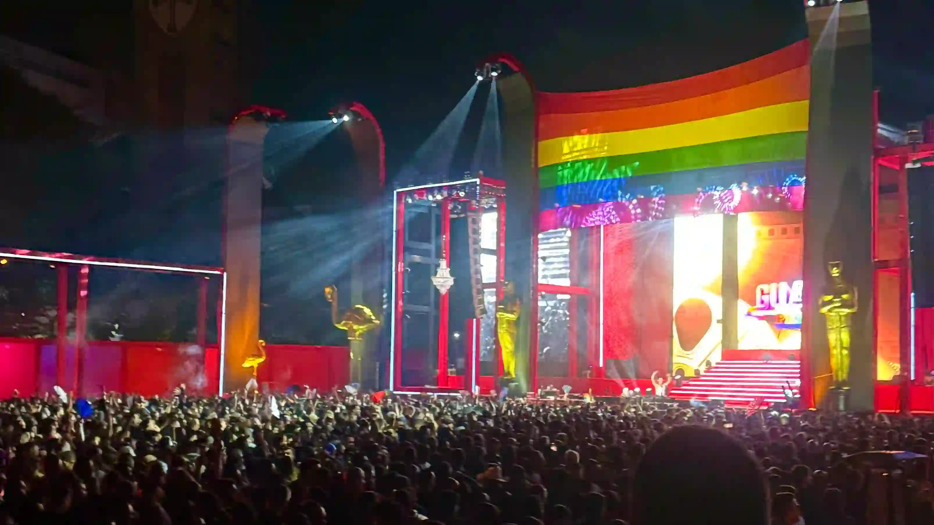 Colorful Pride parade with rainbow flags and celebrating crowds